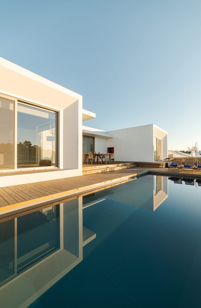 Swimming pool with wooden deck view on Modern villa